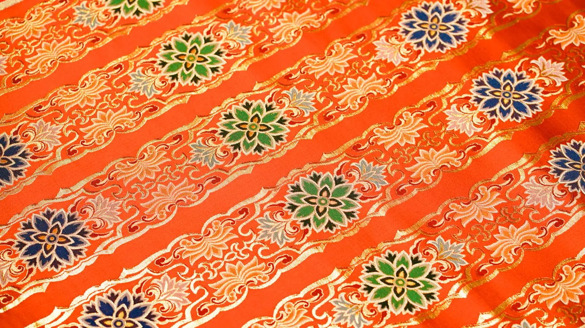 Orange brocade with blue, green and gold flower medallions