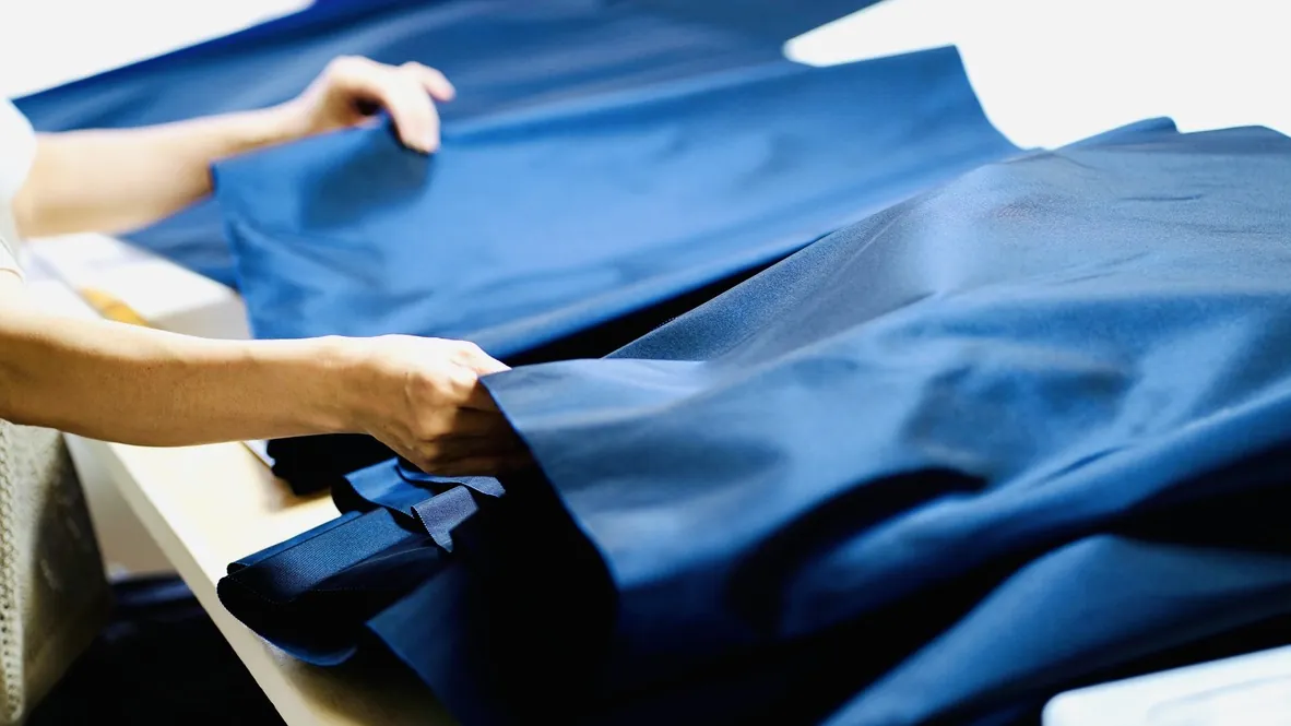 Fabric being folded in a Kyoto workshop